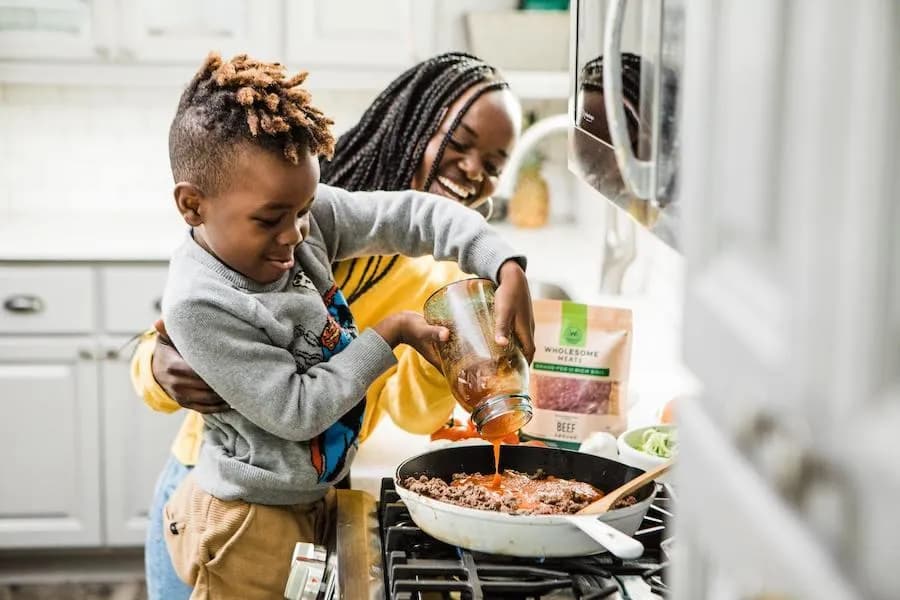 A family cooking together in a kitchen